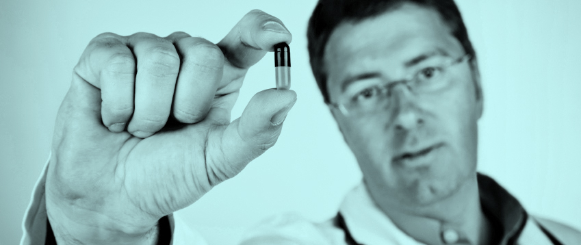 Male doctor holding a medicine capsule